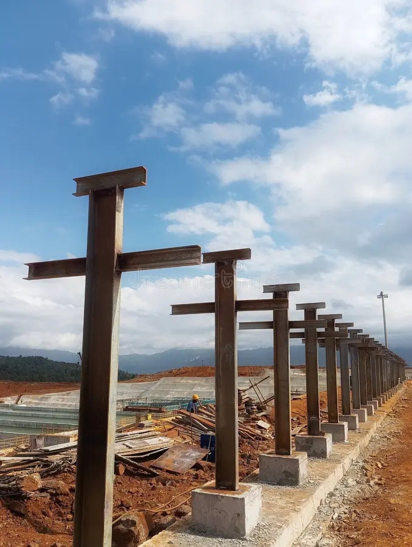 Steel columns set on concrete footings along a highway expansion